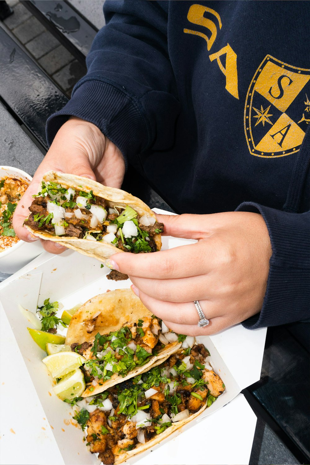 Stock photo of a hand holding a street taco