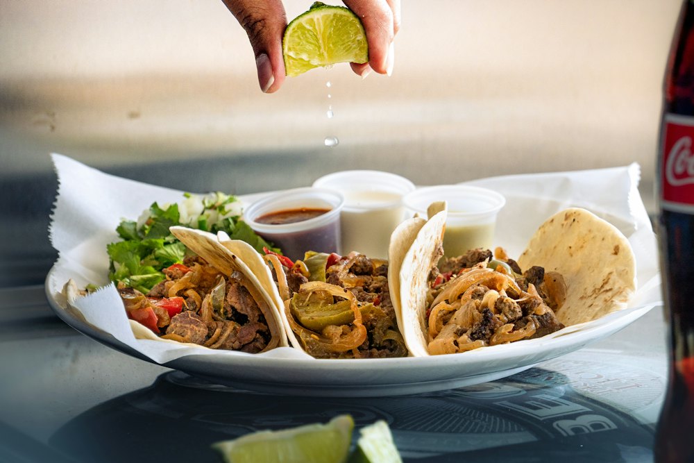 Stock photo of a plate of tacos with lime